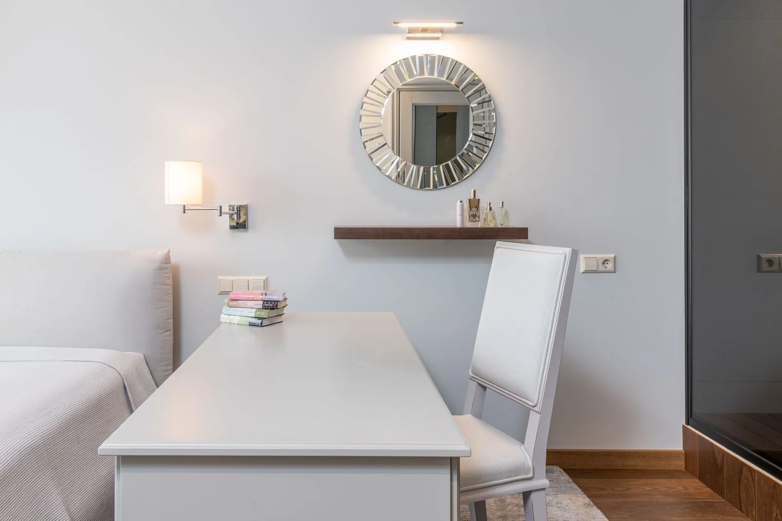 Interior of modern room with white workplace and stylish mirror on light wall in contemporary apartment